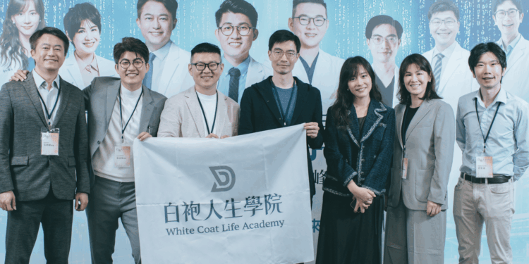 Group of professionals posing with a banner reading White Coat Life Academy.